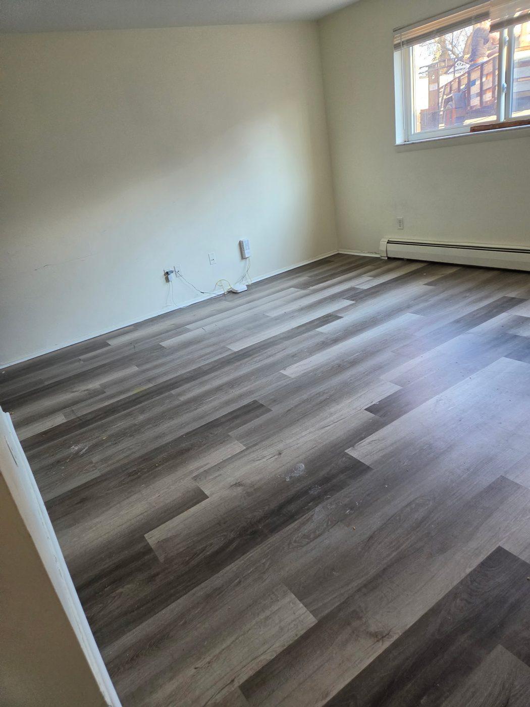 Luxury vinyl plank flooring laid through a room with the edges trimmed in